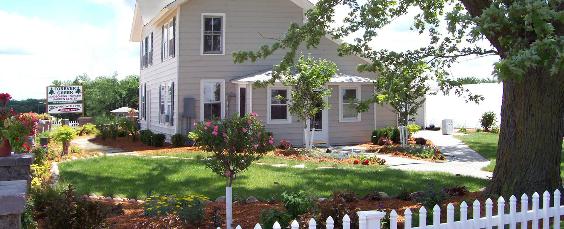 Forever Green Coralville Iowa Who We Are header landscaping house